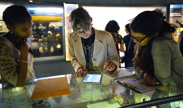 museum patrons using tablet at exhibit