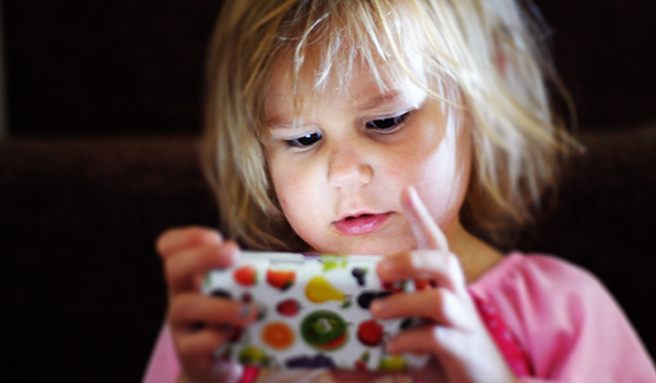 Child heavily focused on phone screen