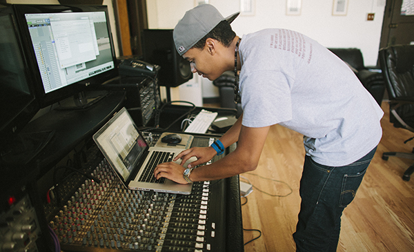 DJ creating music with laptop