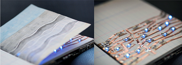 notebook with drawing and electrical wiring on pages with lights