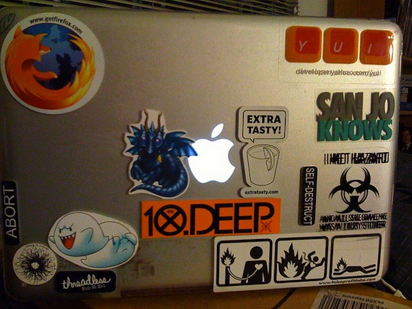 apple macbook laptop covered in stickers