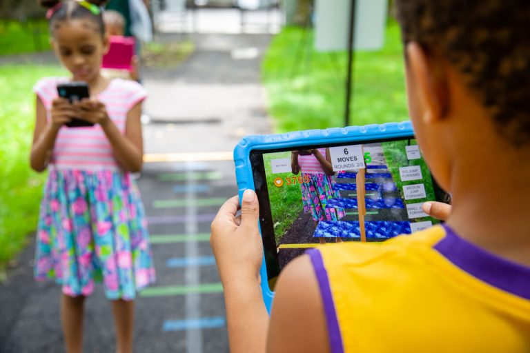 Kids playing math games outdoors on ipads