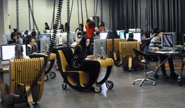 Group of young people working at individual computer stations