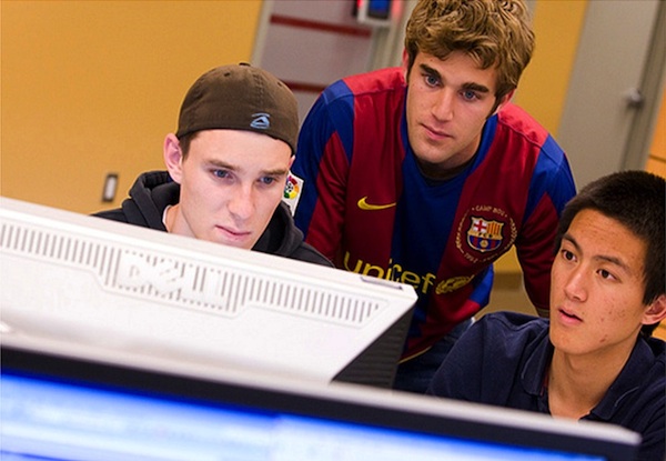 3 male students working together at classroom computer