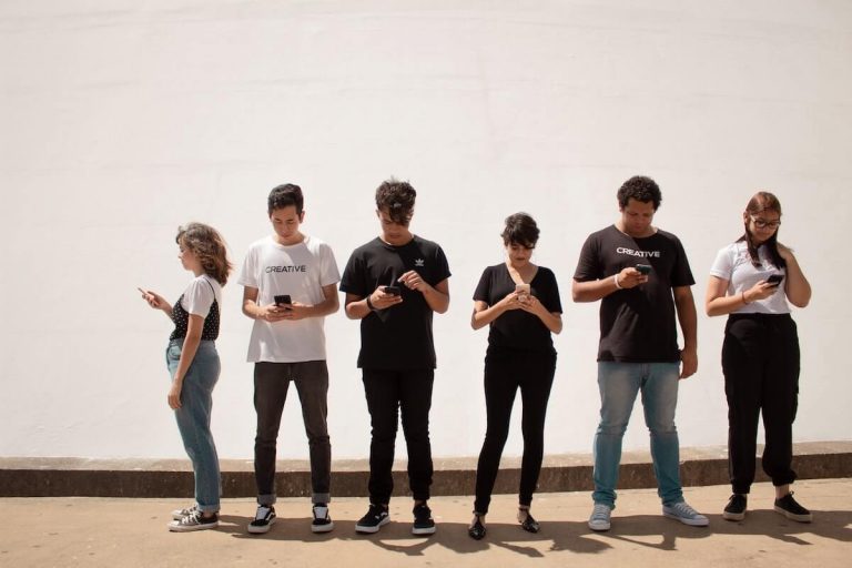 Group of teens looking at smartphones