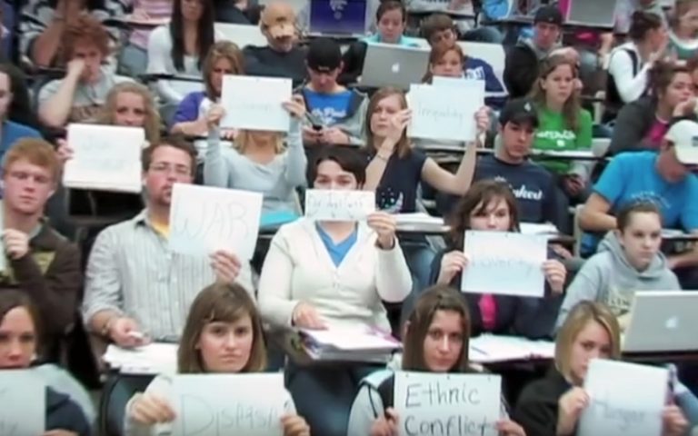 Students in Michael Wesch class holding papers with words written on them