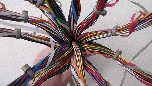 hand holding multi-colored wires bundled up