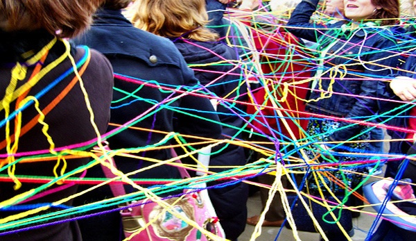 students connected together by colorful strings of yarn