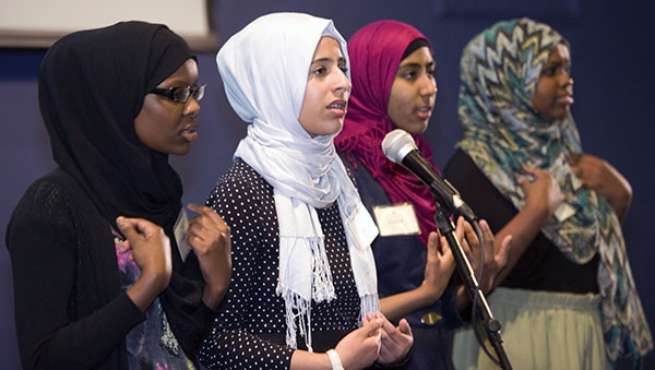 Four Muslim American girls performing slam poetry