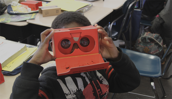 Child using cardboard VR device
