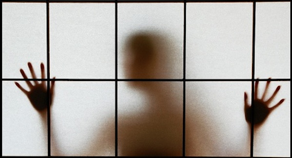person shadow behind window